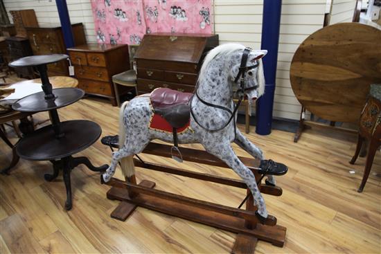 An Edwardian trestle base painted rocking horse, L.4ft 8in.